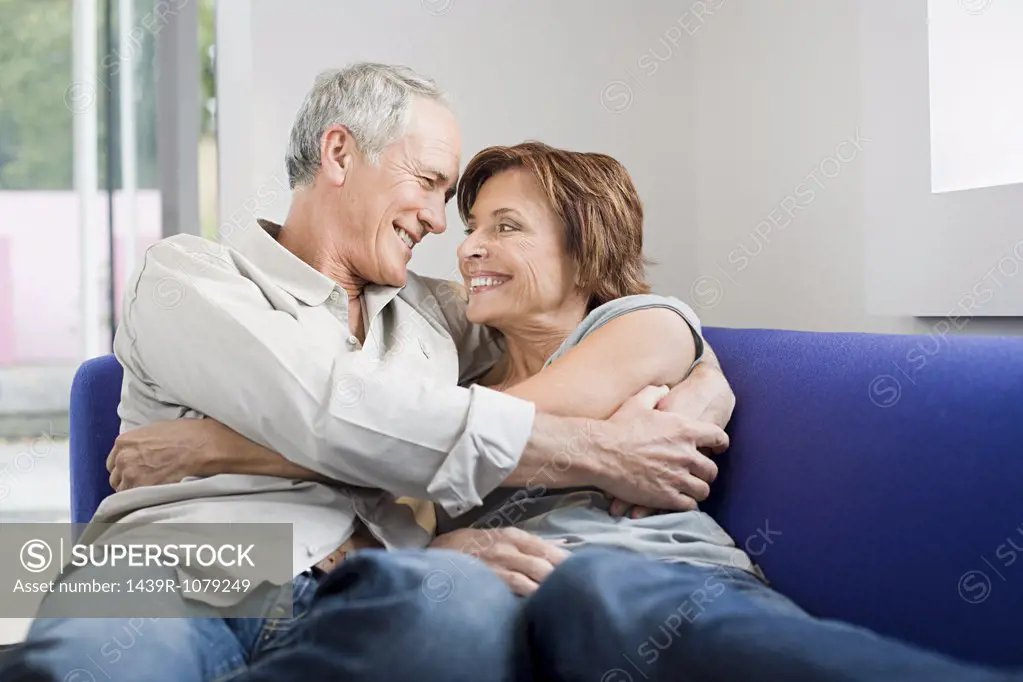 A senior couple hugging