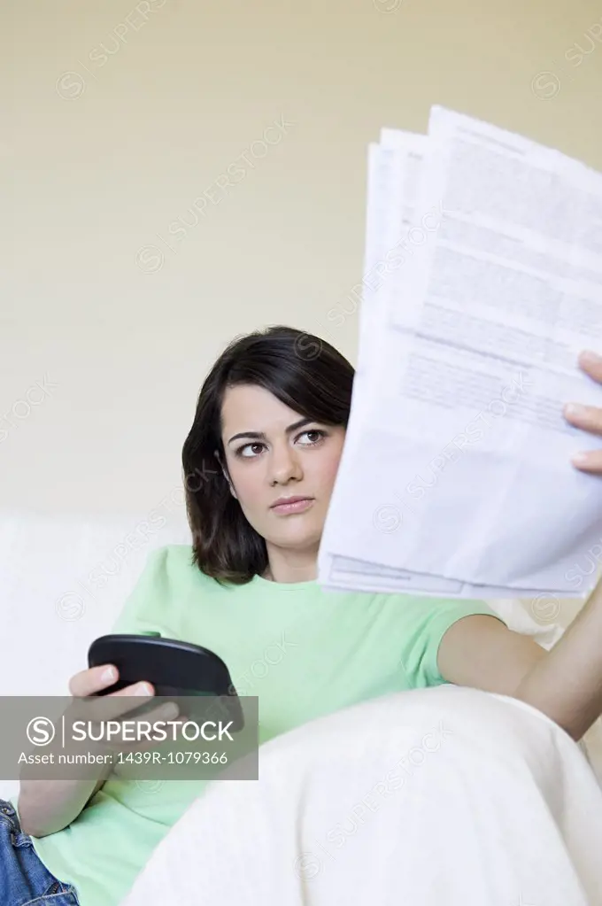 Woman with bills and calculator