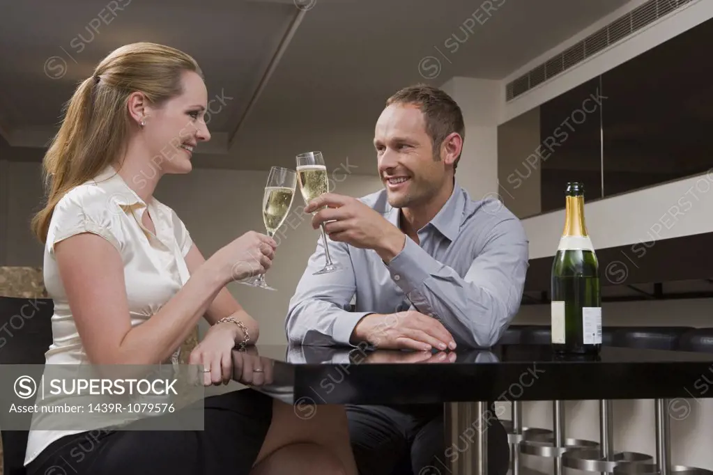 Couple drinking champagne in a bar