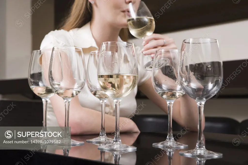 Woman binge drinking wine