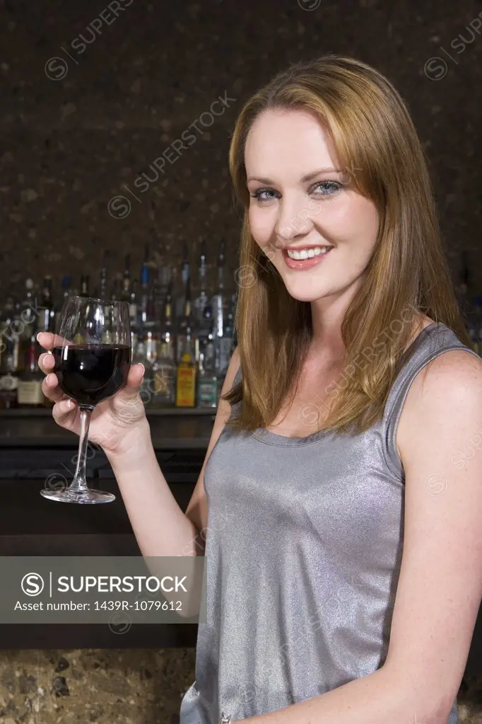 Woman drinking wine in a bar