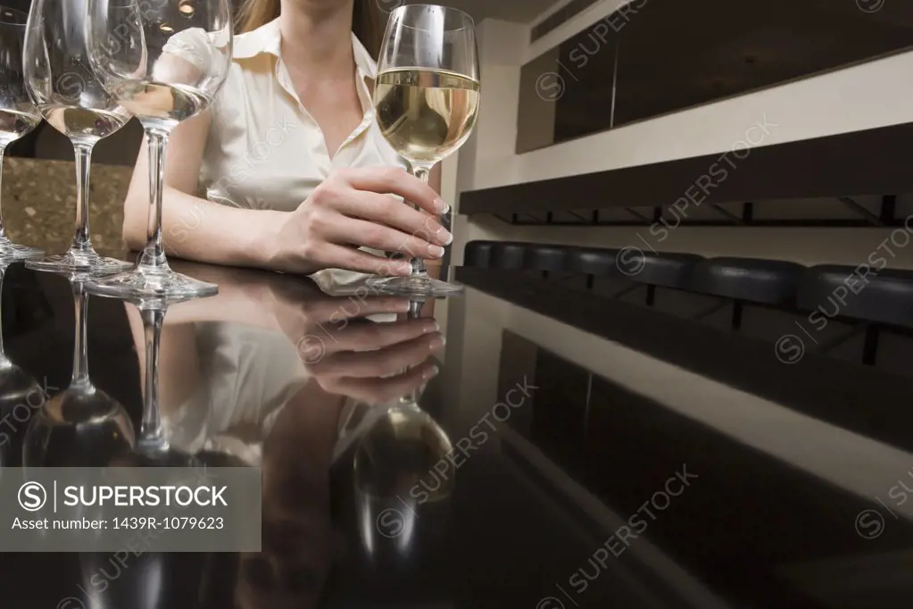 Woman drinking wine in a bar
