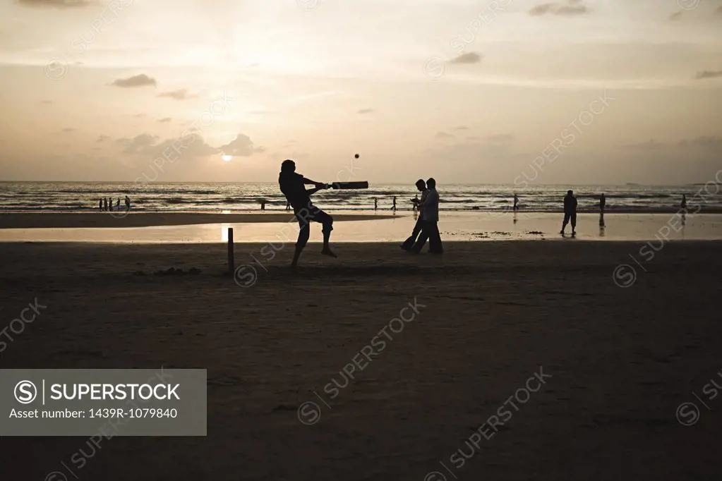 People playing cricket on mumbai beach
