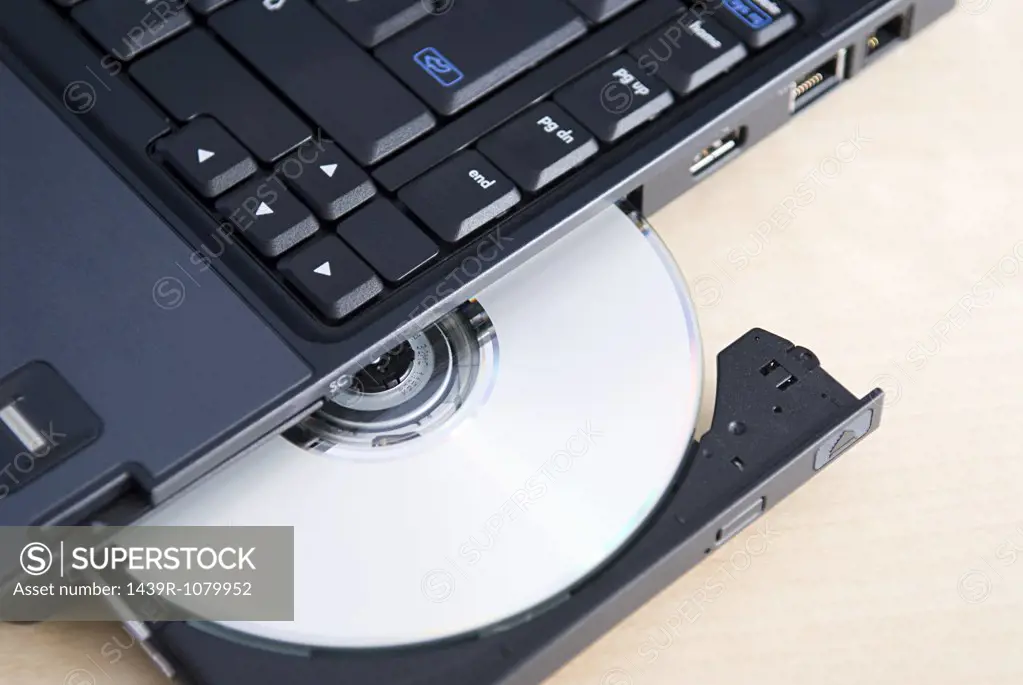 A cd ejecting out of a laptop
