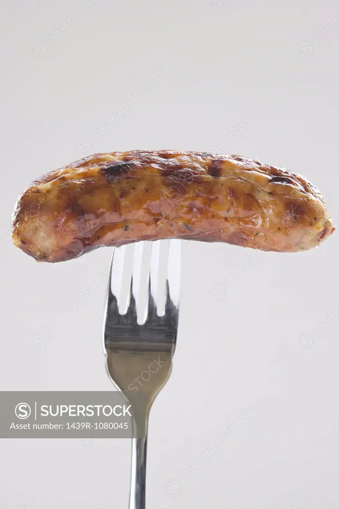 A sausage on a fork