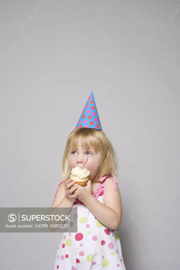 Girl eating a cupcake