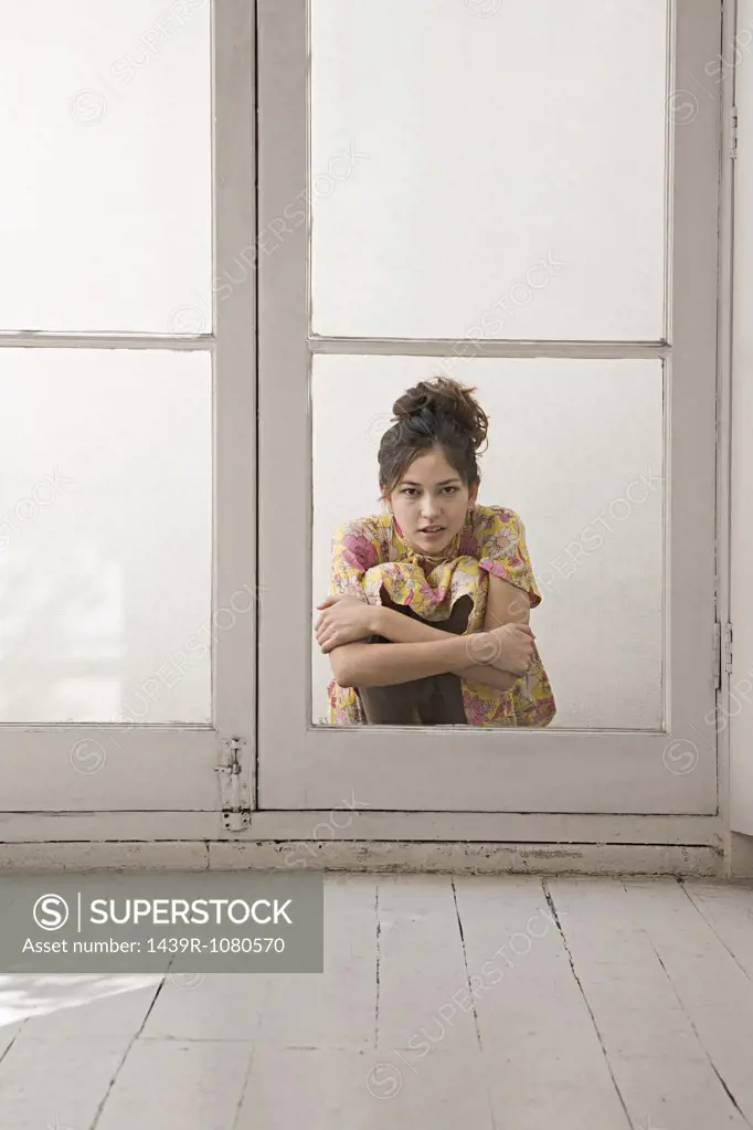 Woman crouching outside