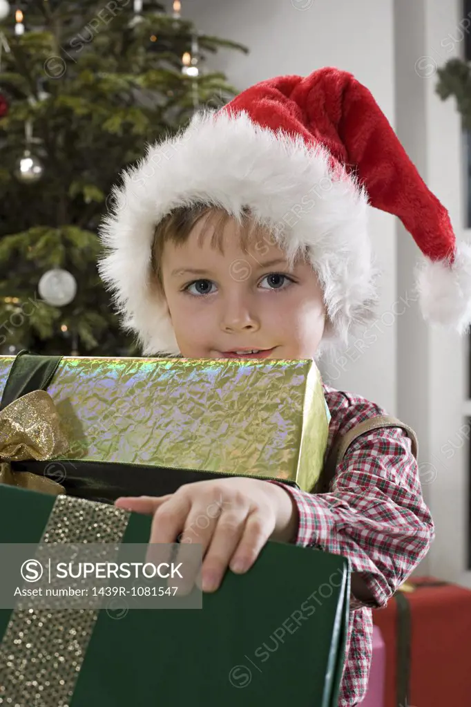 Portrait of a boy holding presents