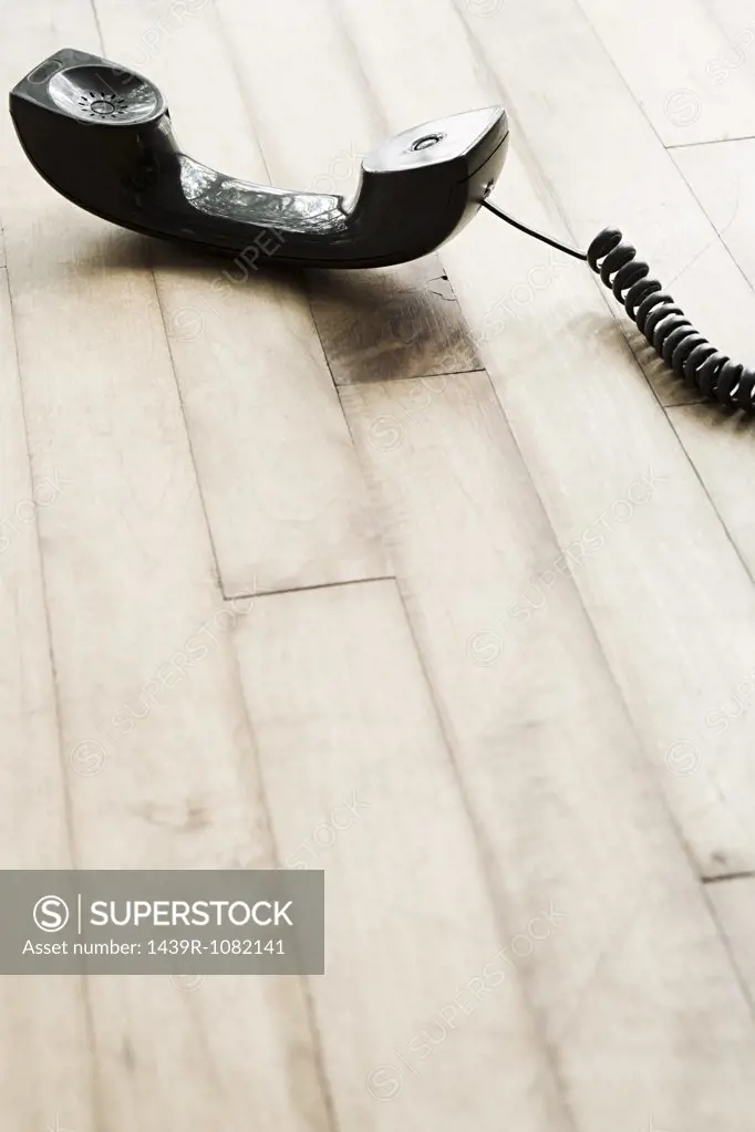 A telephone on a wooden floor
