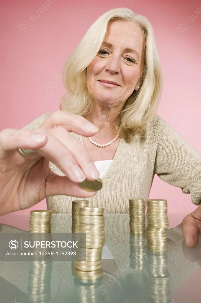 Woman stacking coins