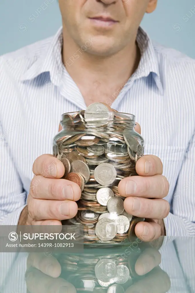 Man with jar of coins
