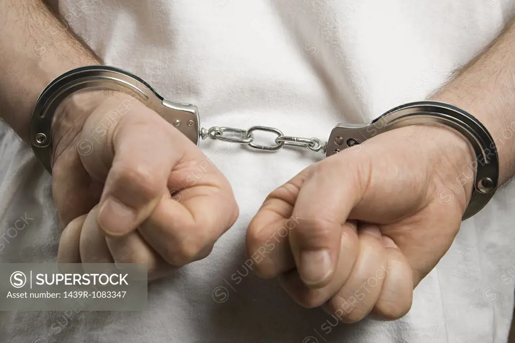 A criminal wearing handcuffs