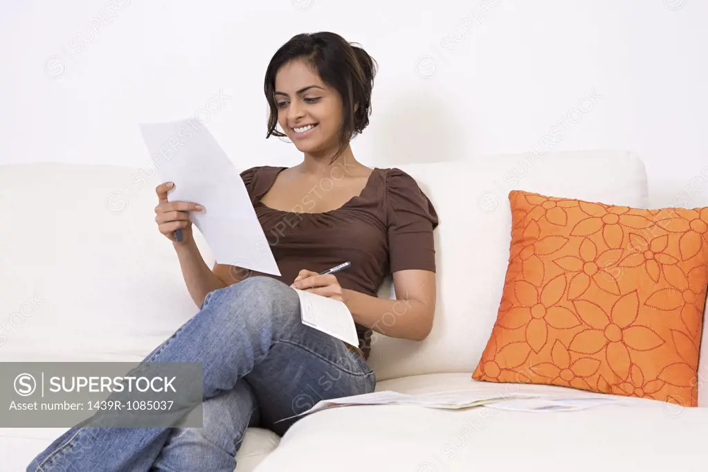 A woman writing a cheque