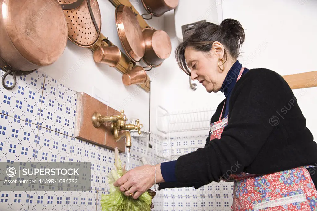 Woman washing lettuce