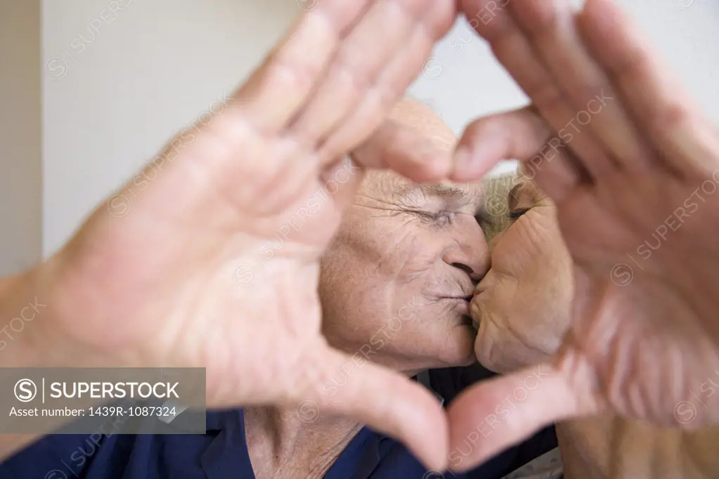 A senior couple kissing