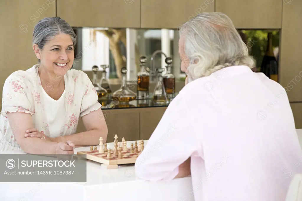 A senior couple playing chess