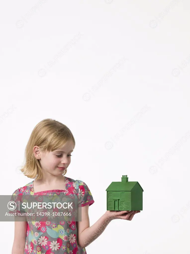 Girl holding a green house
