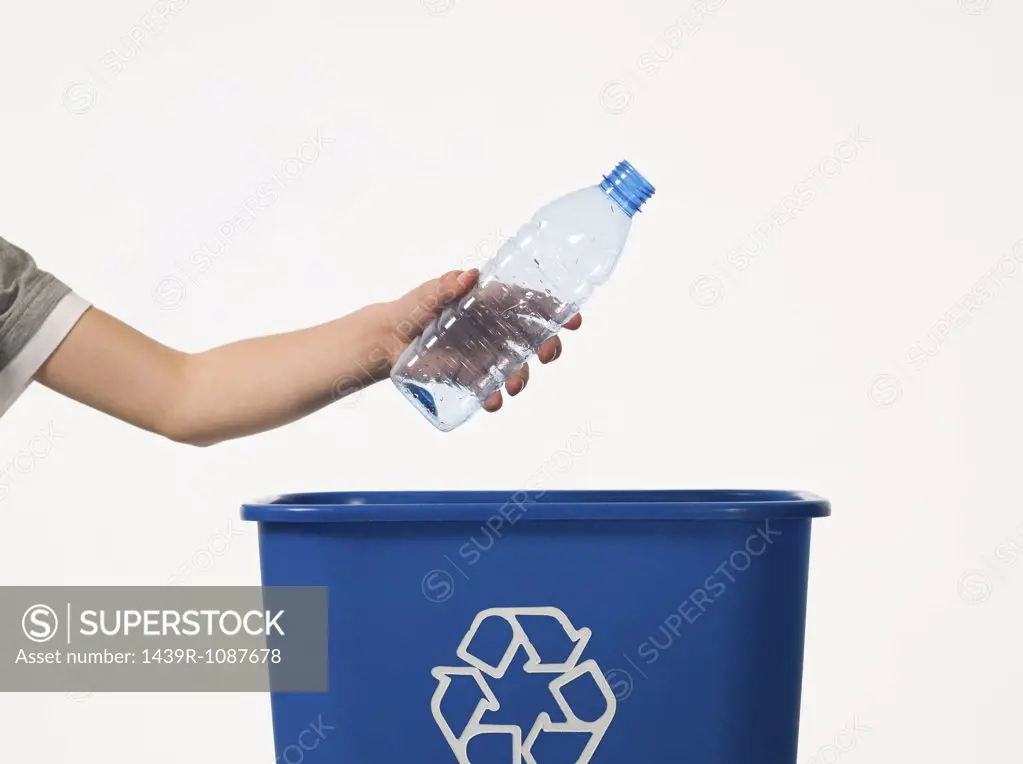 Child recycling a bottle