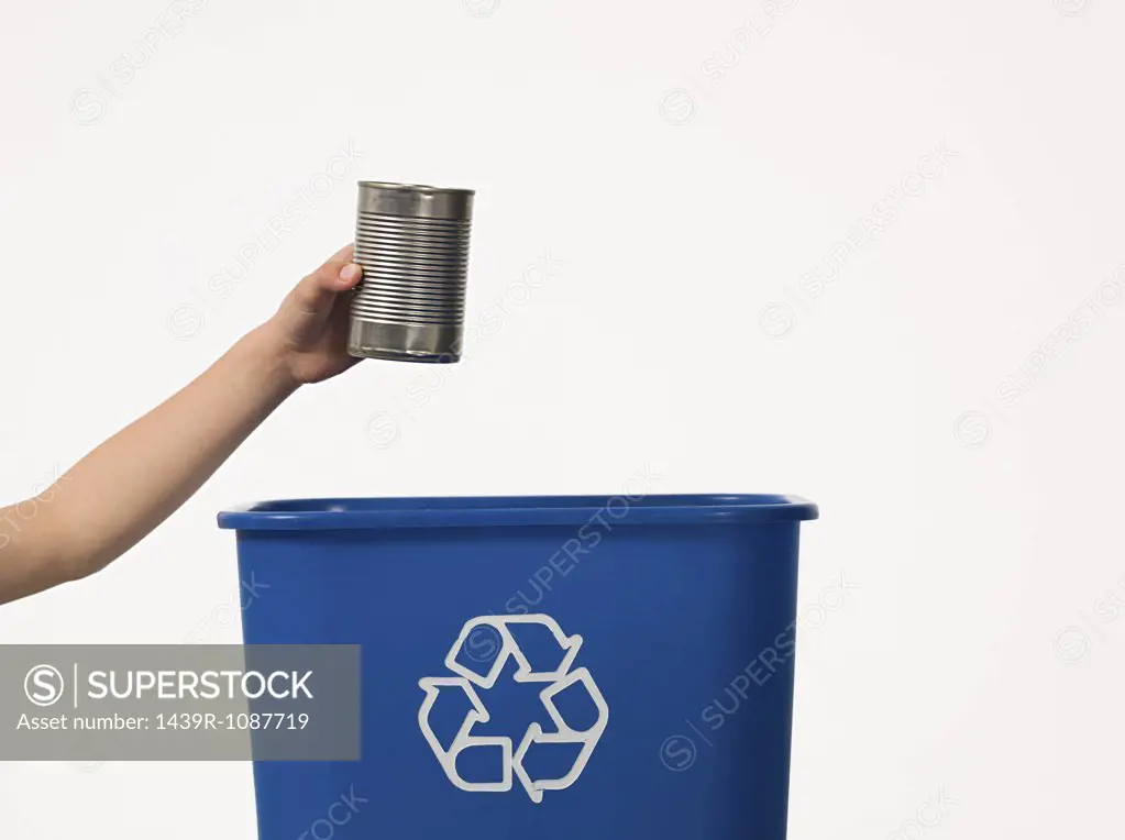 Boy recycling a tin can
