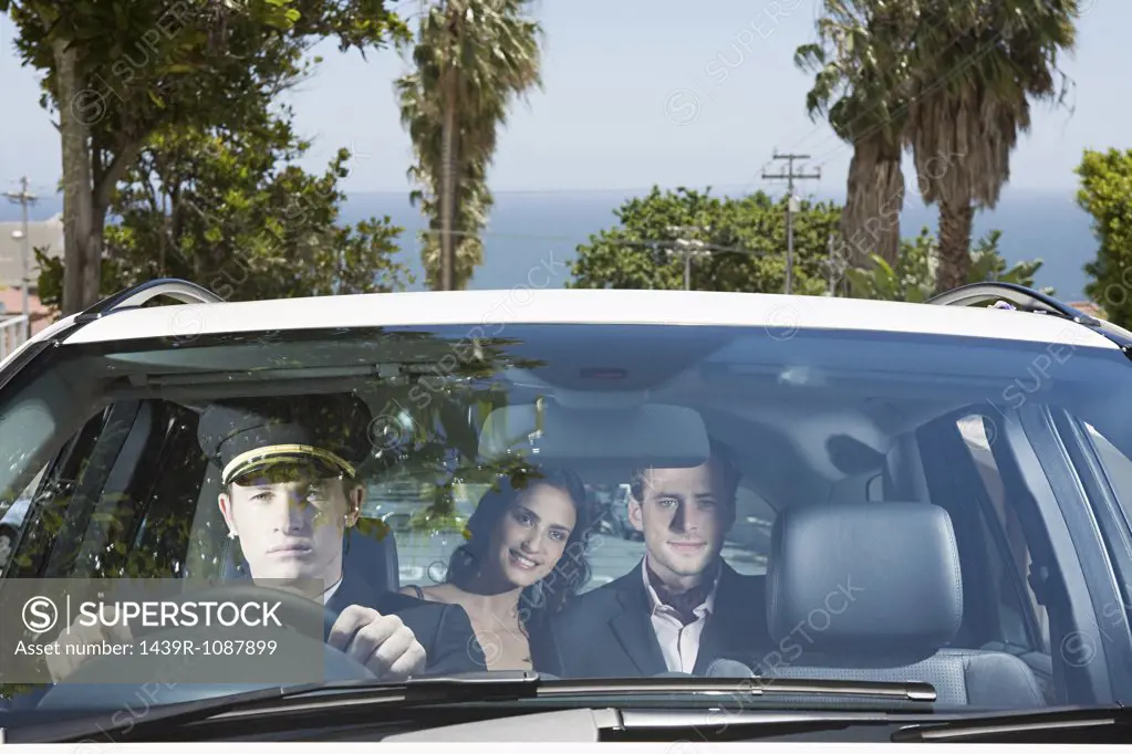 Couple being driven by chauffeur