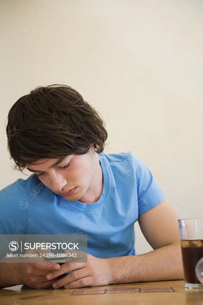 A teenage boy using a cell phone