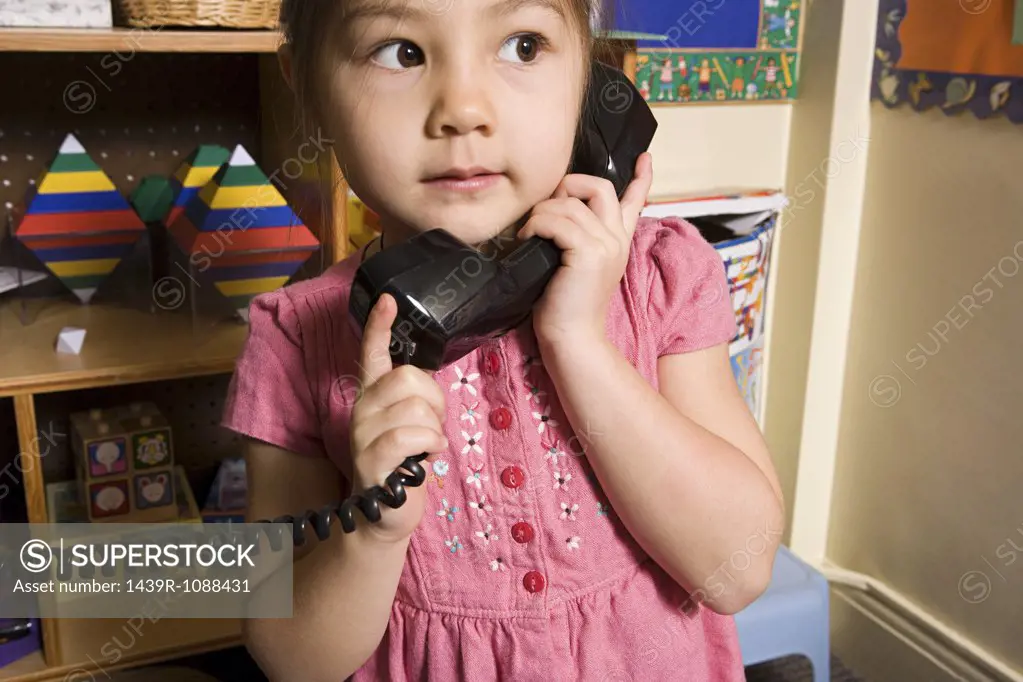 A girl using a telephone