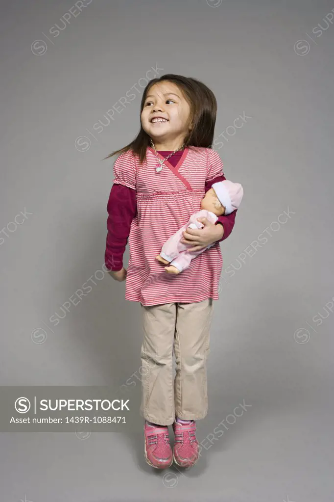 A girl holding a doll