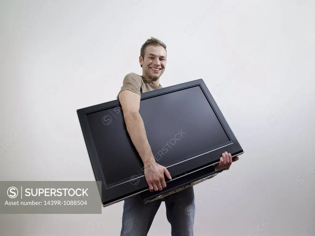 A man holding a tv