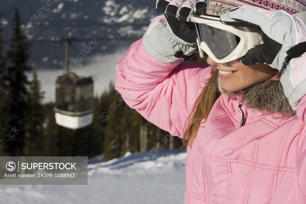 A woman holding a ski mask