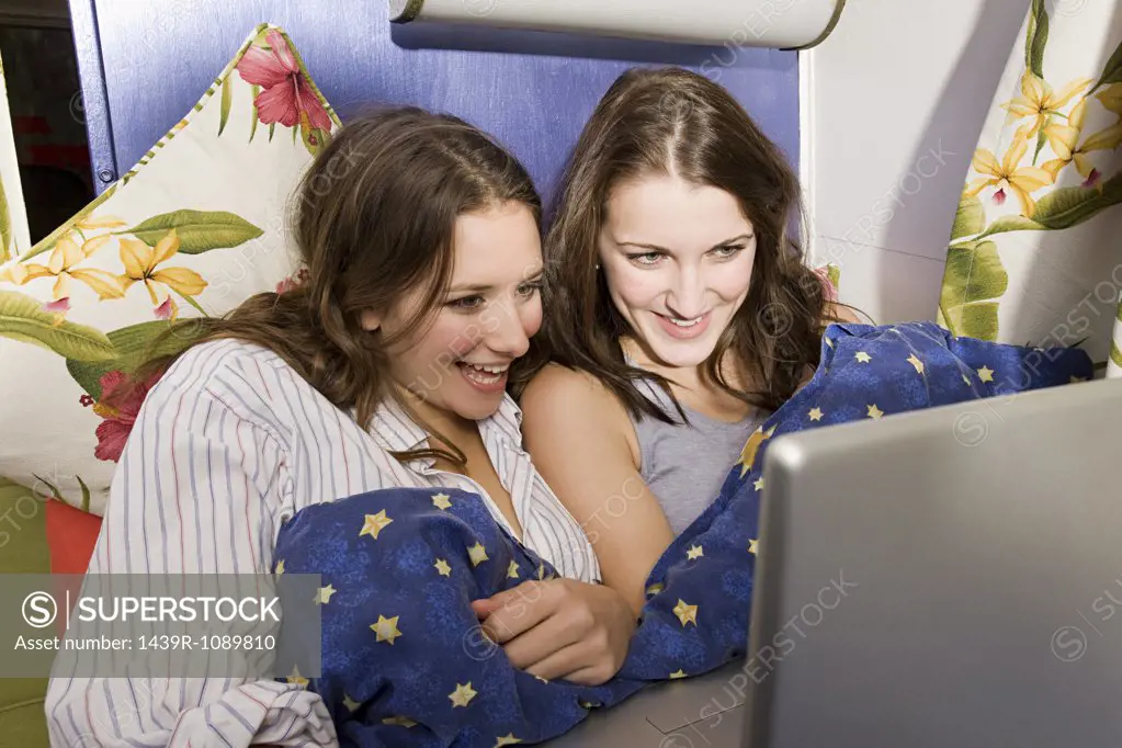 Teenage girls looking at a laptop