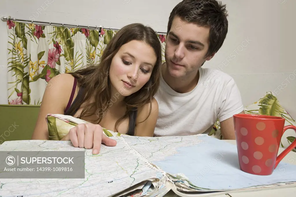 A teenage couple looking at a map