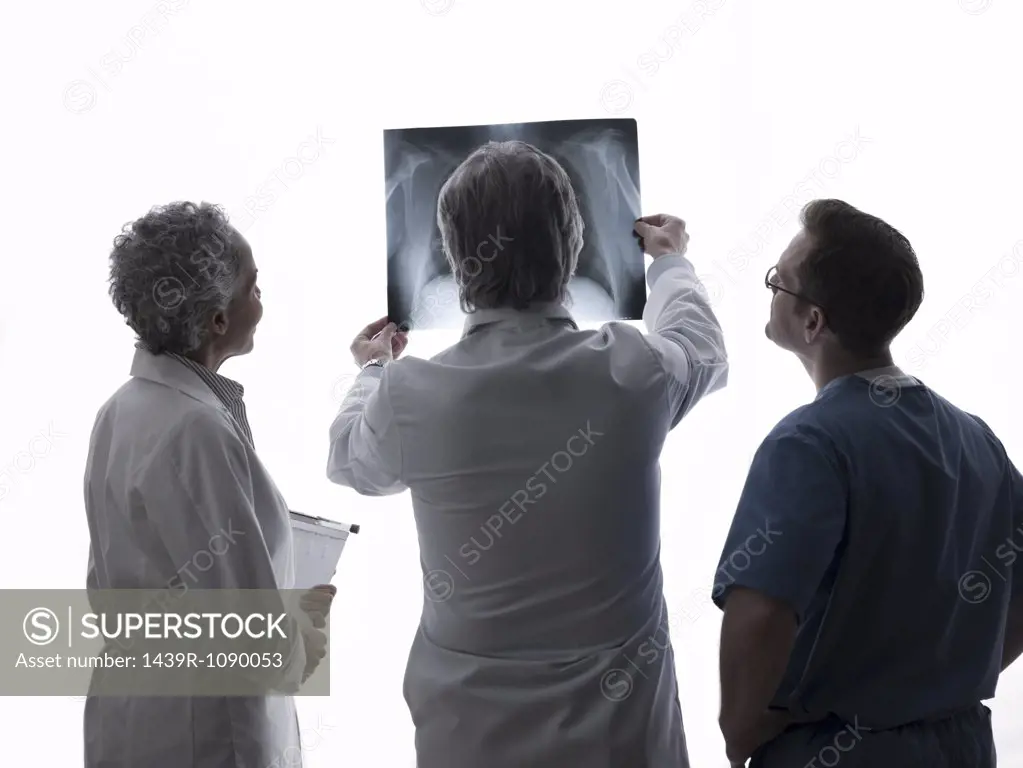 Doctors and surgeon looking at x-ray