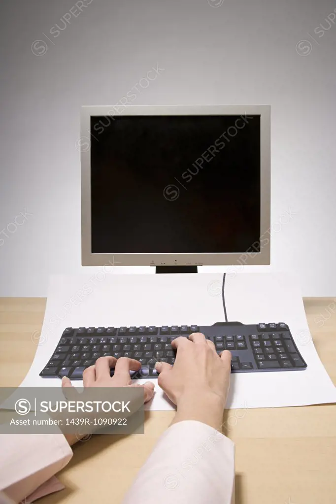 A woman typing on a computer