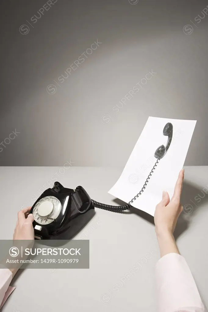 A phone and a photograph of a telephone receiver