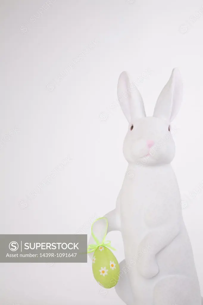 Easter bunny holding an easter egg