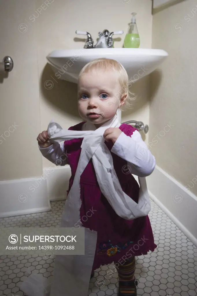 Little girl with toilet paper