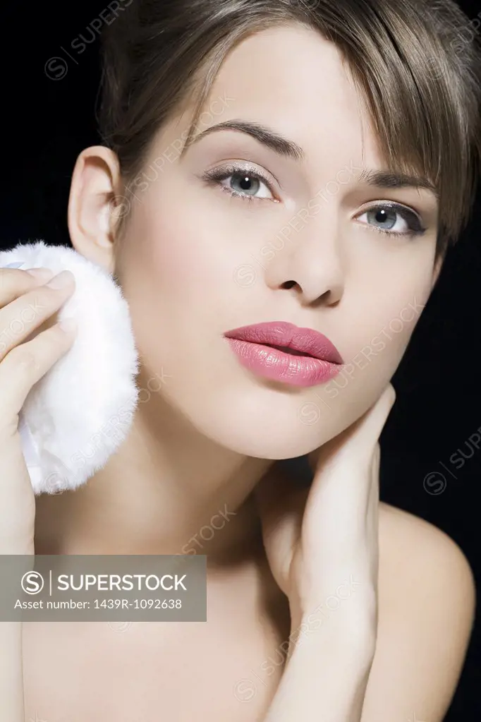 Woman using powder puff
