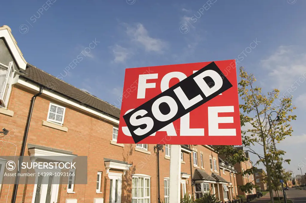 Sold sign and houses