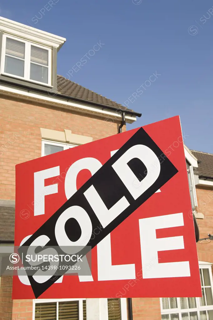 Sold sign and house