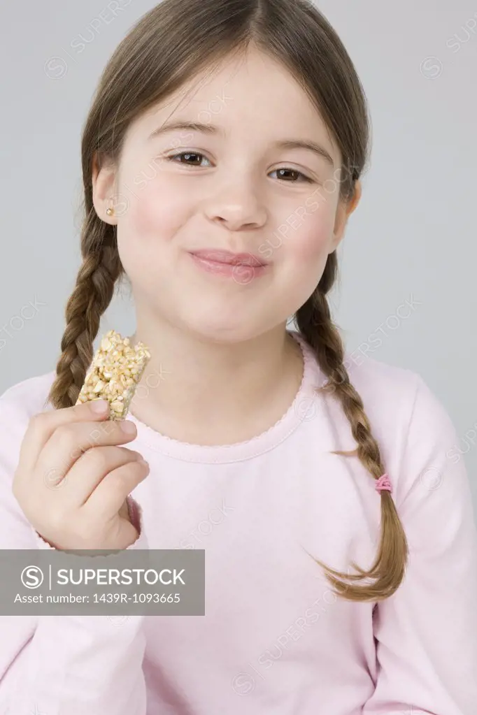 Girl eating cereal bar