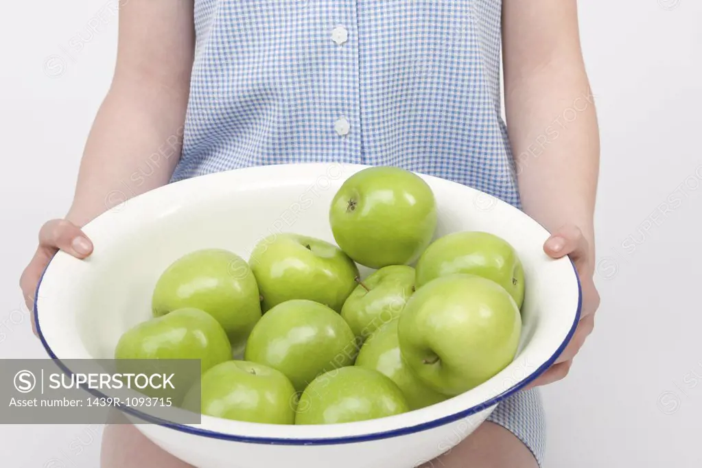Girl with bowl of apples