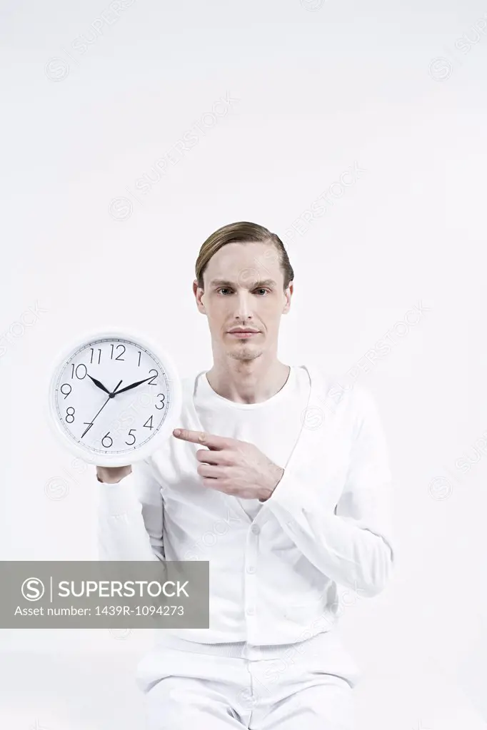 A man holding a clock