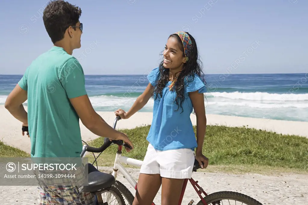 A teenage couple with bikes