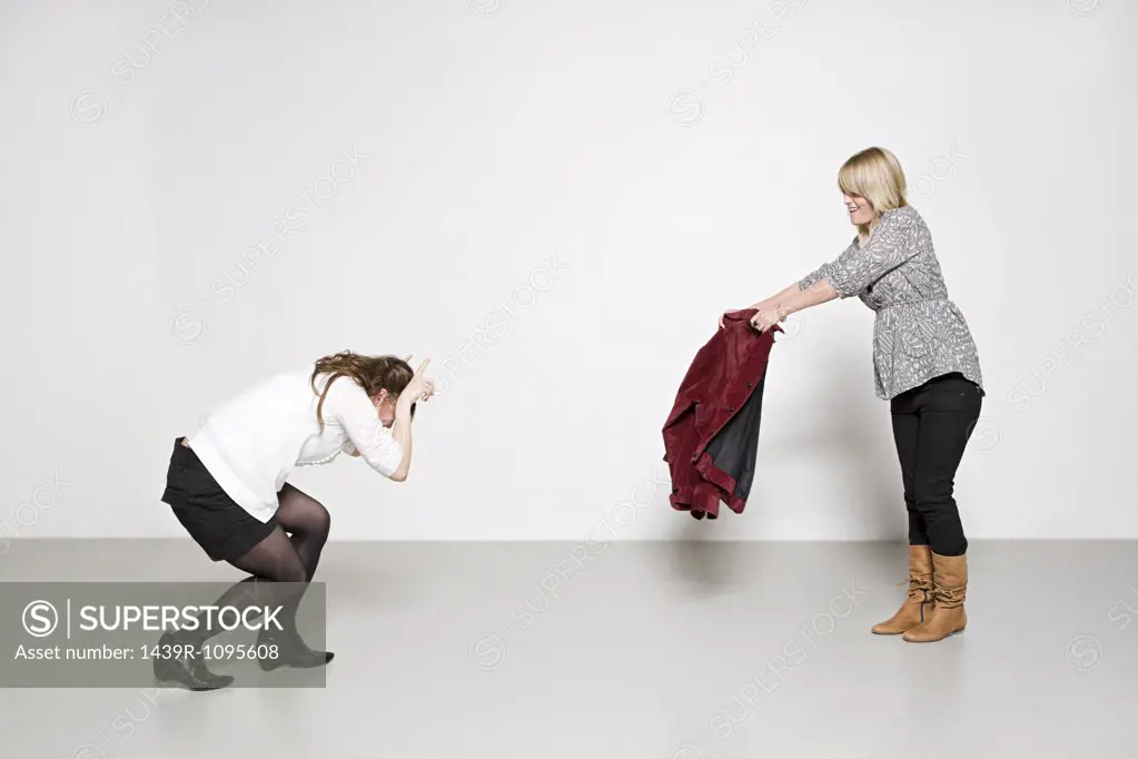 Women pretending to be bull and bullfighter