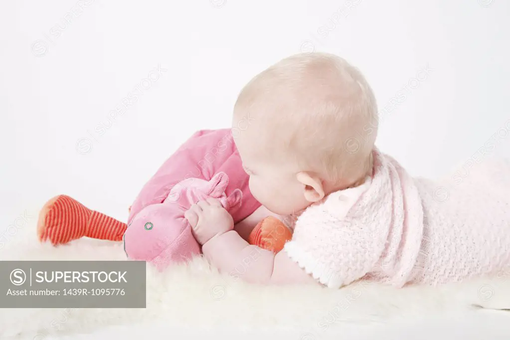 Baby girl holding a toy