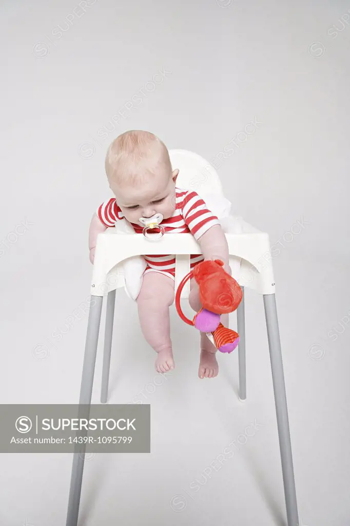 A baby girl in a high chair