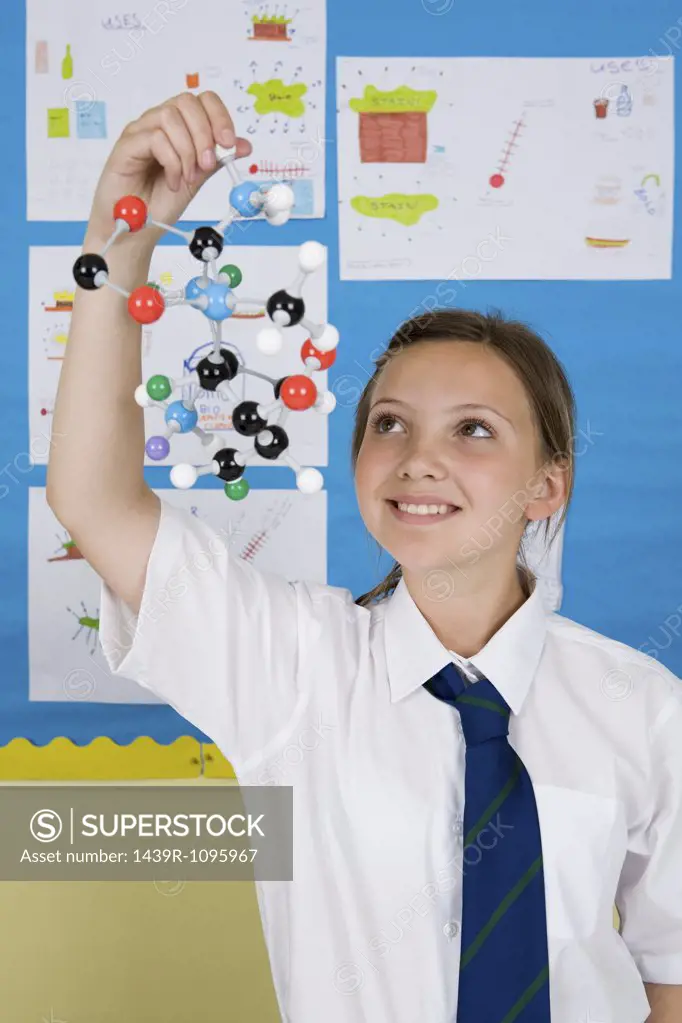 Girl holding molecule model