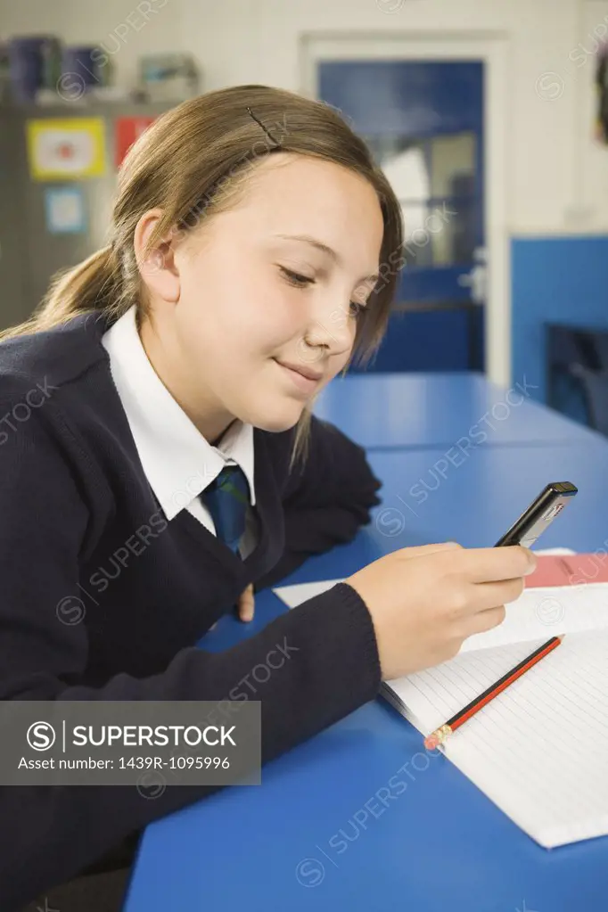 Girl with cellphone in classroom