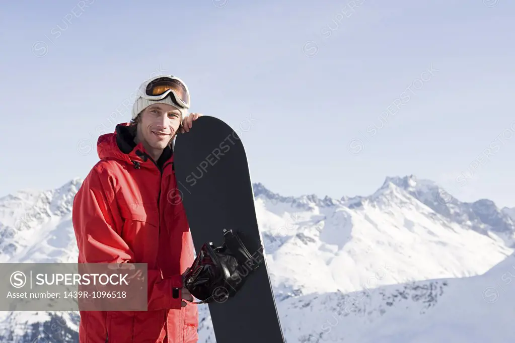 Portrait of a man holding a snowboard