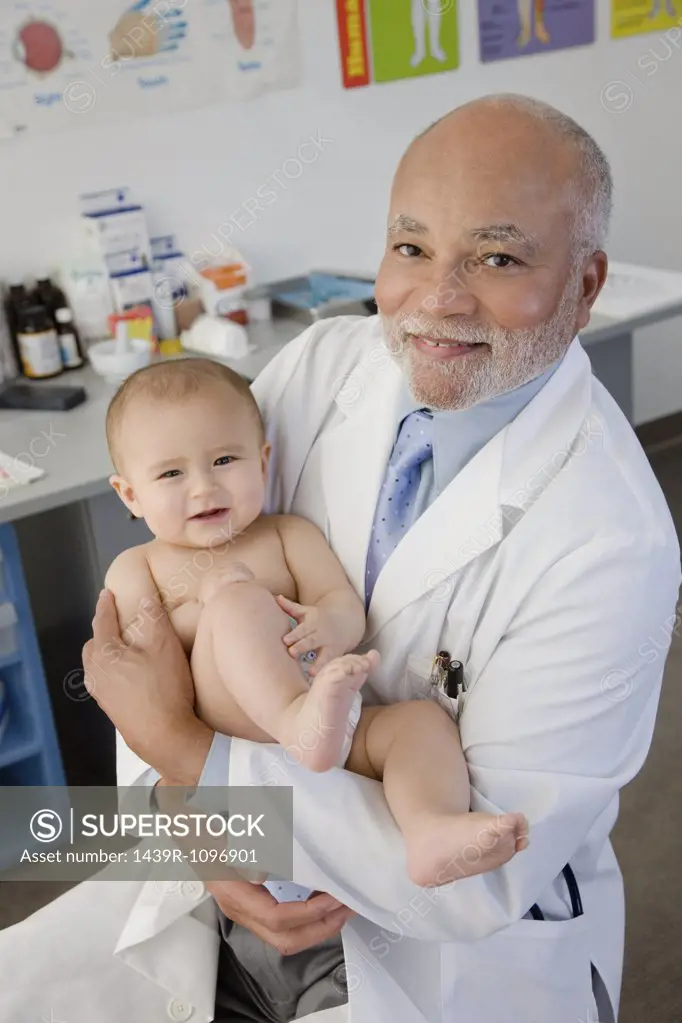 Portrait of a doctor holding a baby